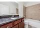 Bathroom featuring a granite vanity, tub-shower combo with tile surround, and neutral decor at 5955 Princeton Run Trl, Tucker, GA 30084