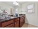 Bathroom featuring double sinks, a granite countertop, wood cabinets, and a large mirror for a functional space at 5955 Princeton Run Trl, Tucker, GA 30084