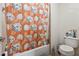Bathroom with a tub and shower, featuring a shower curtain with disco ball design and standard toilet and white walls at 5955 Princeton Run Trl, Tucker, GA 30084
