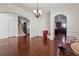 Open-concept dining room with hardwood floors, adjacent to kitchen and staircase at 5955 Princeton Run Trl, Tucker, GA 30084