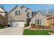 Two story home with a brick and stone facade, attached garage, and newly installed green grass at 5955 Princeton Run Trl, Tucker, GA 30084