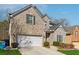 Charming two-story home featuring a brick and stone facade, attached garage, and well-manicured landscaping at 5955 Princeton Run Trl, Tucker, GA 30084