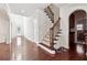 Spacious foyer featuring hardwood floors, a staircase with wooden railing, and arched doorways at 5955 Princeton Run Trl, Tucker, GA 30084