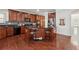 Spacious kitchen boasts wooden cabinets, a central island with bar seating, and stainless steel appliances at 5955 Princeton Run Trl, Tucker, GA 30084