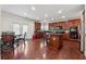 Bright kitchen featuring wooden cabinets, stainless appliances, an island with bar seating, and access to the backyard at 5955 Princeton Run Trl, Tucker, GA 30084