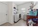 Convenient laundry room features modern appliances, shelving, and bright lighting at 5955 Princeton Run Trl, Tucker, GA 30084