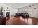 Cozy living room featuring a fireplace, hardwood floors, a large sectional sofa, and ample natural light from large windows at 5955 Princeton Run Trl, Tucker, GA 30084