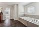 Bathroom showcasing a large soaking tub, ceramic tile floor and an adjacent room at 5955 Princeton Run Trl, Tucker, GA 30084