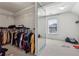Walk-in closet with ample shelving and mirrored door, next to another empty room at 5955 Princeton Run Trl, Tucker, GA 30084