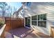 A spacious wood back deck shows outdoor living space with sliding glass doors entrance at 699 Coligny Ct, Atlanta, GA 30350