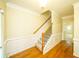 Entryway featuring hardwood floors, neutral paint, a staircase, and white trim work, providing a warm welcome at 699 Coligny Ct, Atlanta, GA 30350