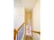 Carpeted staircase with wood railing and black iron balusters going to the lower level at 699 Coligny Ct, Atlanta, GA 30350