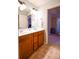 Bathroom with double sink vanity, tile flooring, and a doorway to an adjacent room at 160 Edgewater Trl, Fayetteville, GA 30215