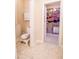 Bathroom with a toilet and view into organized walk-in closet with shelving at 160 Edgewater Trl, Fayetteville, GA 30215