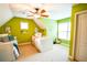 Sunlit bedroom boasts a neutral carpet, bright green paint, and a ceiling fan at 160 Edgewater Trl, Fayetteville, GA 30215