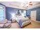 Serene bedroom with blue walls, bay window, and tray ceiling, perfect for relaxation at 160 Edgewater Trl, Fayetteville, GA 30215