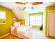 Well-lit green-painted bedroom features a ceiling fan and a neutral carpet at 160 Edgewater Trl, Fayetteville, GA 30215