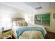 Sunlit bedroom featuring a luxurious bed, mirrored side tables, and a view to the peaceful outdoors at 160 Edgewater Trl, Fayetteville, GA 30215