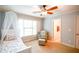 Bedroom with a chair, large window and ceiling fan at 160 Edgewater Trl, Fayetteville, GA 30215