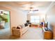 Upstairs bonus room with ceiling fan, a couch, and a view to an adjacent bedroom at 160 Edgewater Trl, Fayetteville, GA 30215