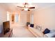 Upstairs bonus room with couch, TV, and view to hallway leading to other rooms at 160 Edgewater Trl, Fayetteville, GA 30215