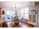 Bright dining area with a round wooden table, chandelier, and access to the deck at 160 Edgewater Trl, Fayetteville, GA 30215