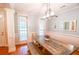 Bright dining room featuring a wooden table, wainscoting, and modern light fixture at 160 Edgewater Trl, Fayetteville, GA 30215