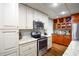 Kitchen featuring stainless steel appliances, granite countertops, and a combination of white and wood cabinets at 160 Edgewater Trl, Fayetteville, GA 30215