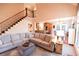 Inviting living room with staircase, large sectional, and view of the kitchen at 160 Edgewater Trl, Fayetteville, GA 30215