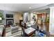 Cozy living area with fireplace, adjacent to an open kitchen featuring stainless steel appliances at 160 Edgewater Trl, Fayetteville, GA 30215