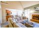 Cozy living room with fireplace, vaulted ceiling, and open view to the kitchen at 160 Edgewater Trl, Fayetteville, GA 30215