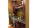 Granite countertop bar with dark wood cabinets and wine rack at 4312 Defoors Farm Trl, Powder Springs, GA 30127