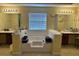 Large bathroom with a tub and dual sinks underneath mounted lighting at 4312 Defoors Farm Trl, Powder Springs, GA 30127