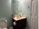 Bathroom with a pedestal sink, mirror, and toilet next to a linen closet at 4312 Defoors Farm Trl, Powder Springs, GA 30127