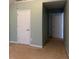 The bedroom features neutral walls, carpet, and a closet door for functional living space at 4312 Defoors Farm Trl, Powder Springs, GA 30127