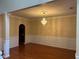 Elegant dining room featuring hardwood floors and a stunning crystal chandelier at 4312 Defoors Farm Trl, Powder Springs, GA 30127