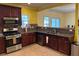 Well-equipped kitchen featuring stainless steel appliances, granite countertops, and wood cabinets at 4312 Defoors Farm Trl, Powder Springs, GA 30127