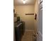 This laundry room features modern washer and dryer, shelving, and coat hooks for convenience at 4312 Defoors Farm Trl, Powder Springs, GA 30127