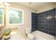 Bathroom featuring modern tile, granite countertops, and a tub with shower at 455 Dollar Mill Sw Rd, Atlanta, GA 30331