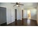 Bedroom featuring hardwood floors, ceiling fan, and access to closets and a bathroom at 455 Dollar Mill Sw Rd, Atlanta, GA 30331