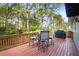 Back deck with outdoor seating and a grill overlooking the backyard at 1421 Eryn Cir, Suwanee, GA 30024