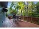 Back deck with outdoor seating overlooking a private backyard with mature trees at 1421 Eryn Cir, Suwanee, GA 30024