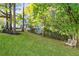 Expansive green backyard view of the house showcasing mature trees providing a private setting at 1421 Eryn Cir, Suwanee, GA 30024