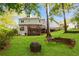 Large, well-maintained backyard with a fire pit, seating, and mature trees at 1421 Eryn Cir, Suwanee, GA 30024