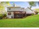 Sprawling backyard with a deck, patio, screened-in porch, and lush green lawn at 1421 Eryn Cir, Suwanee, GA 30024