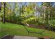 Lush backyard featuring a hammock with mature trees offering shade for relaxation at 1421 Eryn Cir, Suwanee, GA 30024