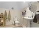 Well-lit bathroom with a pedestal sink, decorative fixtures, and soft towels for a spa-like experience at 1421 Eryn Cir, Suwanee, GA 30024