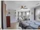 Light-filled bedroom featuring a ceiling fan, large windows, and a comfortable bed with stylish bedding at 1421 Eryn Cir, Suwanee, GA 30024
