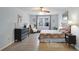 This airy bedroom features wood-look floors, a unique headboard, and a sitting area near a bright window at 1421 Eryn Cir, Suwanee, GA 30024