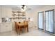 Bright dining area with table, shelving and french doors for indoor/outdoor living at 1421 Eryn Cir, Suwanee, GA 30024